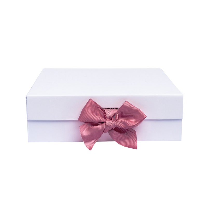 May include: A white gift box with a pink satin bow.