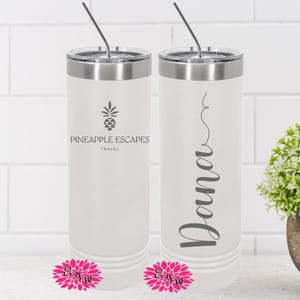 May include: Two white stainless steel tumblers with lids and straws. One tumbler has the text "Pineapple Escapes Travel" and a pineapple graphic. The other tumbler has the name "Donna" written in cursive.