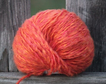92 yards of Soft and fuzzy comforting wool-containing orange yarn with sparkle.