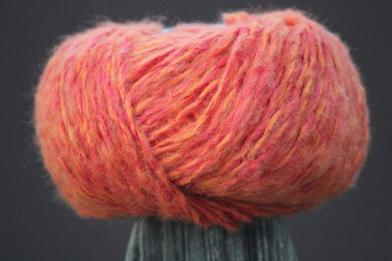 92 yards of Soft and fuzzy comforting wool-containing orange yarn with sparkle.