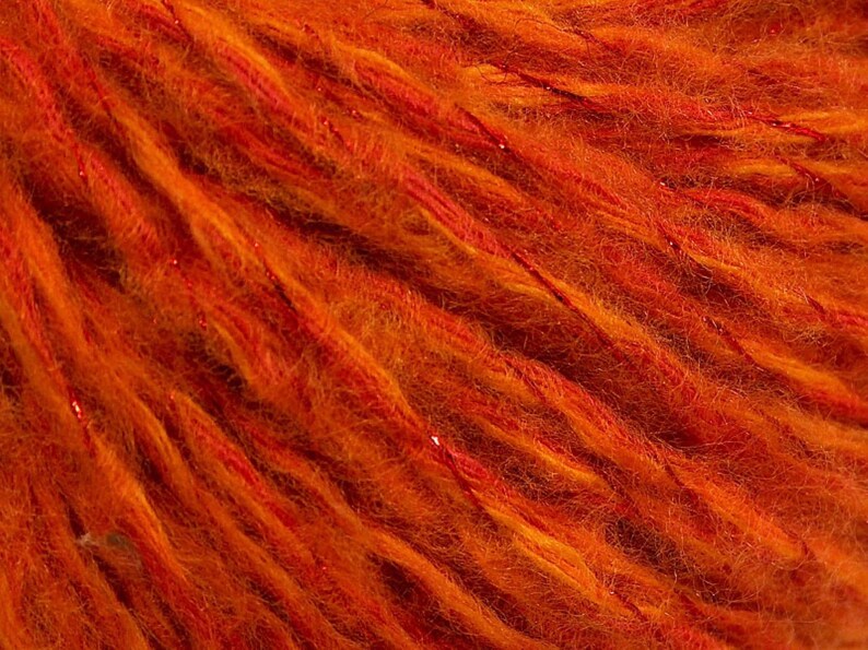 92 yards of Soft and fuzzy comforting wool-containing orange yarn with sparkle.
