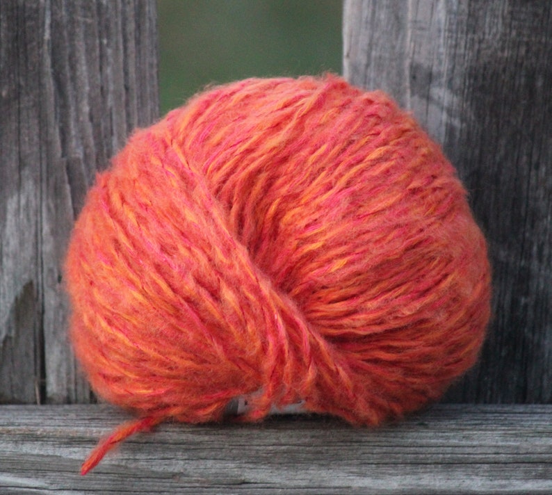92 yards of Soft and fuzzy comforting wool-containing orange yarn with sparkle.