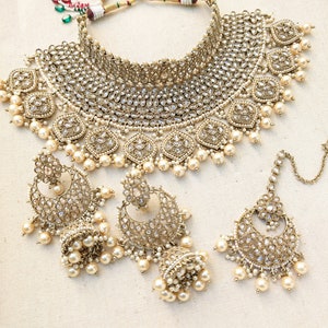 Gold necklace set with chandbali earrings and tikka. Polki choker necklace set. Indian wedding jewelry. Pakistani wedding jewelry. Bollywood necklace set. Punjabi jewelry set. Kundan necklace jhumka. Antique gold-plated necklace. Champagne stones.
