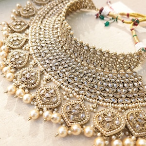 Gold necklace set with chandbali earrings and tikka. Polki choker necklace set. Indian wedding jewelry. Pakistani wedding jewelry. Bollywood necklace set. Punjabi jewelry set. Kundan necklace jhumka. Antique gold-plated necklace. Champagne stones.