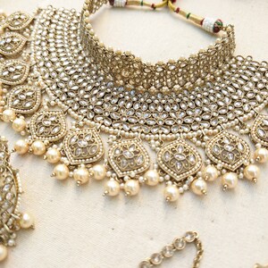 Gold necklace set with chandbali earrings and tikka. Polki choker necklace set. Indian wedding jewelry. Pakistani wedding jewelry. Bollywood necklace set. Punjabi jewelry set. Kundan necklace jhumka. Antique gold-plated necklace. Champagne stones.