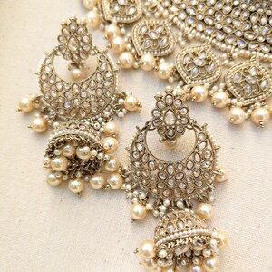 Gold necklace set with chandbali earrings and tikka. Polki choker necklace set. Indian wedding jewelry. Pakistani wedding jewelry. Bollywood necklace set. Punjabi jewelry set. Kundan necklace jhumka. Antique gold-plated necklace. Champagne stones.