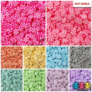 May include: Assortment of colorful candy-shaped polymer clay sprinkles with a white swirl design. The sprinkles are not edible and are perfect for crafting and decorating.