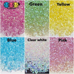 May include: Six containers of iridescent glitter, each with a different color: pink, green, yellow, blue, clear white, and pink. The containers are labeled with the color of the glitter.