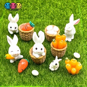 May include: A set of miniature white bunny figurines, carrots, and eggs in wicker baskets. The figurines are arranged on a green grass surface. The set is perfect for decorating a miniature garden or fairy garden.