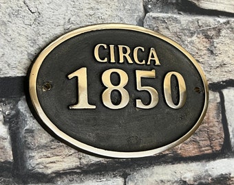 May include: Oval brass plaque with the text "CIRCA 1850" in gold lettering on a black background.