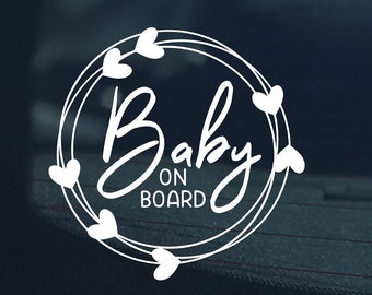 May include: White vinyl sticker with a circle of hearts around the text "Baby on Board".