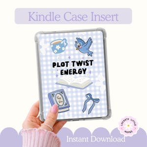 May include: A clear Kindle case insert featuring a light blue and white gingham background with illustrations of a blue mug, a blue bird, an open book, a book titled Fairy Tales, and a blue ribbon, with the text PLOT TWIST ENERGY in black.