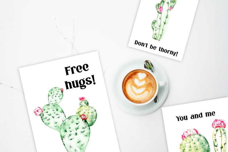 May include: Three printable cards with watercolor cactus illustrations and text. The first card says "Free hugs!" and features a green cactus with pink flowers. The second card says "Don't be thorny!" and features a green cactus with pink flowers. The third card says "You and me" and features two green cacti with pink flowers.