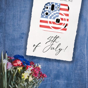 May include: A white card with the text "HAVE A GREAT 4th of July!" and a red, white, and blue camera with stars and stripes.