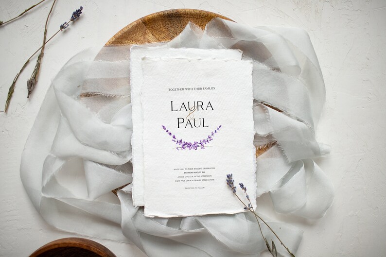 May include: Wedding invitation with a white background and a purple lavender floral design. The invitation reads "Together with their families, Laura & Paul".