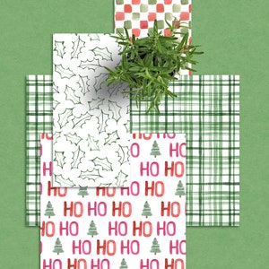 May include: Four different Christmas wrapping paper designs. The first design is a white background with green holly leaves. The second design is a white background with red and green "HO HO HO" text and small green Christmas trees. The third design is a white background with green and red plaid. The fourth design is a white background with red and green squares.
