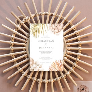 May include: A wedding invitation with a white background and watercolor illustrations of palm leaves, roses, and proteas. The text reads "Together with their families, Sebastian & Johanna, Invite you to join them for the celebration of their love and marriage, May 25th, 2023, at 4 pm, Sanctuary Park, 170 Royal Street, Brydon, Amsterdam, Reception to follow."