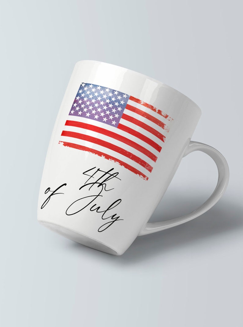 May include: White ceramic mug with a red, white, and blue American flag design and the text "4th of July" in black cursive script.