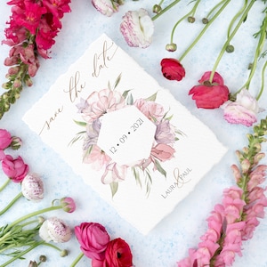May include: Save the date card with watercolor floral design and the date 12.09.2021. The card is surrounded by pink and white flowers.