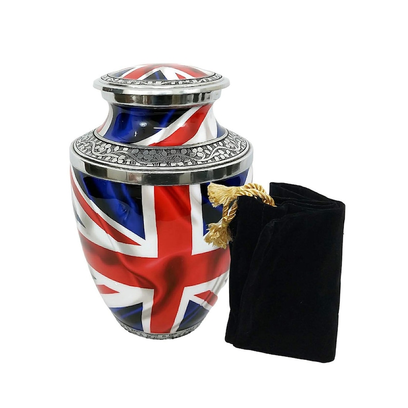 May include: A silver urn with a Union Jack flag design. The urn has a lid and comes with a black velvet bag.