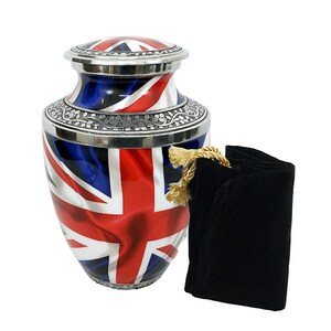 May include: A silver urn with a Union Jack flag design. The urn has a silver lid and a black velvet bag.
