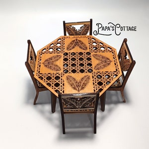 May include: A miniature wooden dining set with a round octagonal table and four chairs. The table and chairs are decorated with a woven pattern and leaf designs. The table top is a light brown color, while the chairs are a darker brown. The set is made by Papa's Cottage.