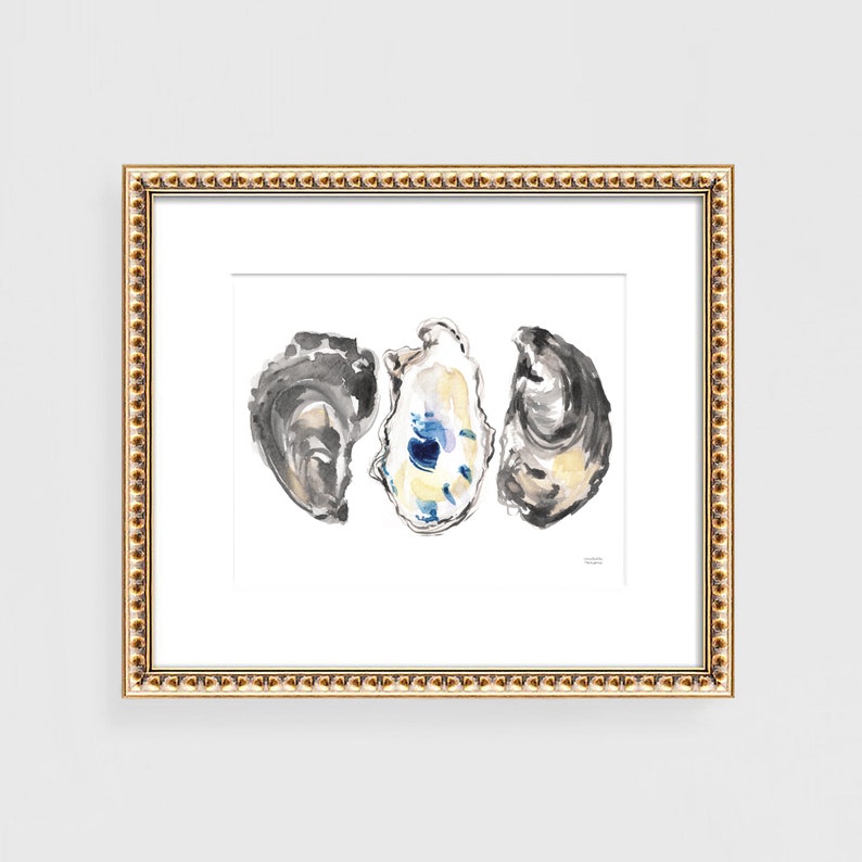 May include: A watercolor painting of three oyster shells. The shells are painted in shades of gray, white, and blue. The painting is framed in a gold frame.