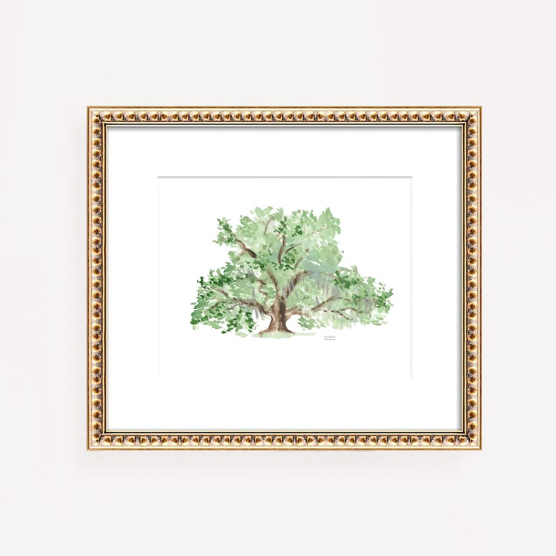 May include: A watercolor painting of a large, green oak tree with a thick trunk and spreading branches. The tree is framed in a gold frame with a beaded edge.