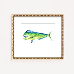 May include: A framed watercolor print of a mahi-mahi fish. The fish is depicted in shades of green, blue, and yellow, with a detailed fin and tail. The artwork is set against a white background and framed in a gold-colored frame.