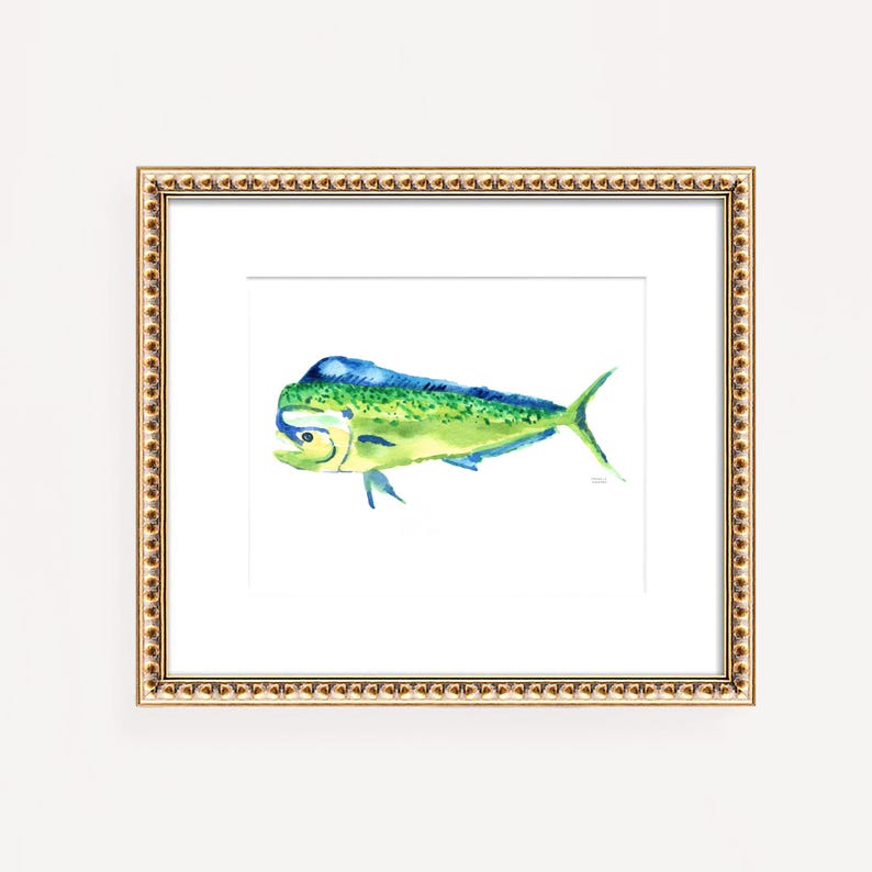 May include: A framed watercolor print of a mahi-mahi fish. The fish is depicted in shades of green, blue, and yellow, with a detailed fin and tail. The artwork is set against a white background and framed in a gold-colored frame.