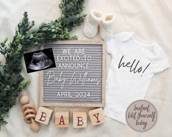 May include: A gray letter board with the text "We are excited to announce Baby Williams April 2024". A white onesie with the text "hello!" is next to the letter board. A wooden rattle and wooden blocks spelling "BABY" are in front of the letter board. An ultrasound image is in the top left corner of the image.