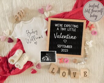 May include: A white onesie with the text "Baby Williams" and a heart, a red blanket, a black chalkboard with the text "We're expecting a tiny little Valentine September 2023", a white ultrasound image, and wooden blocks spelling "LOVE".