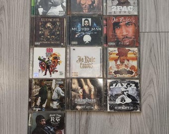 Lotto di CD Hip Hop Vintage con 2Pac, Snoop Dogg, Jay Z, Eminem, Ludacris, Method Man, Ja Rule e RZA. Collezione di musica rap con 13 dischi.