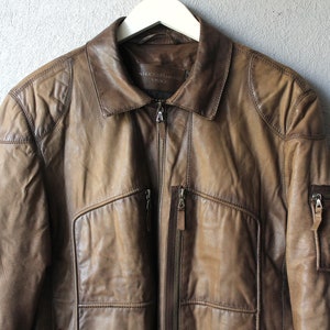 May include: A handmade wooden sign with the text "Welcome" in a playful font. The sign features a distressed white background and a dark brown frame, perfect for a front door or entryway. The sign measures approximately 12 inches wide and 6 inches tall.