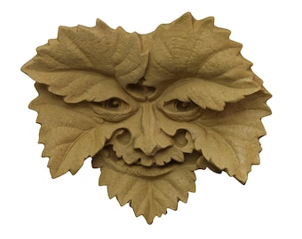 May include: A carved wooden green man mask with a leafy design. The mask has a wide mouth, large eyes, and a prominent nose.