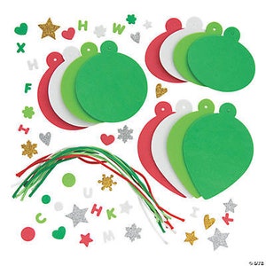 May include: A craft kit for making Christmas ornaments. The kit includes red, white, and green felt ornaments, green and red yarn, and various embellishments like stars, hearts, and letters.