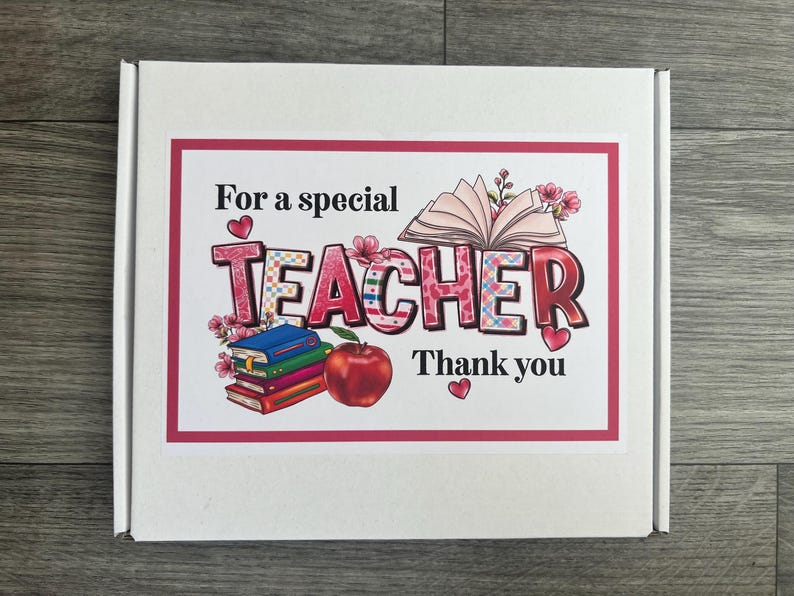 May include: White gift box with a pink and red border featuring the text "For a special TEACHER Thank you." The word TEACHER is in a colorful plaid pattern with floral accents. An open book, stack of books, and a red apple are also shown.