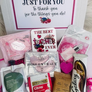May include: A gift box filled with self-care items. Includes a lip mask, eye patches, face mask, tea, soap, a chocolate bar, and a candle. The box has a message that reads "A Special Gift JUST FOR YOU To thank you for the things you do!" and a "The Best Teacher Ever" coaster.