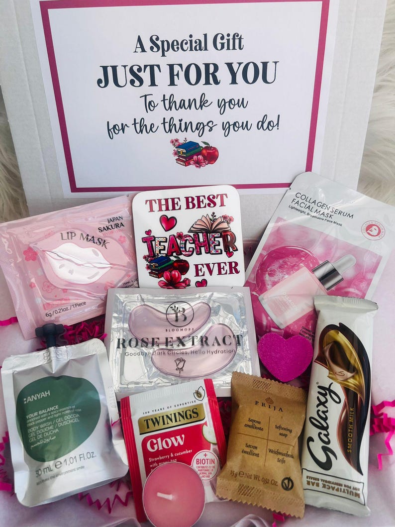 May include: A gift box filled with self-care items. Includes a lip mask, eye patches, face mask, tea, soap, a chocolate bar, and a candle. The box has a message that reads "A Special Gift JUST FOR YOU To thank you for the things you do!" and a "The Best Teacher Ever" coaster.