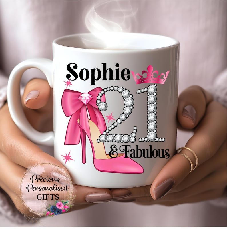 May include: A white ceramic mug with a black handle and the text "But First, Coffee" in a bold, black font. The mug is set against a blurred background, suggesting a cosy setting.