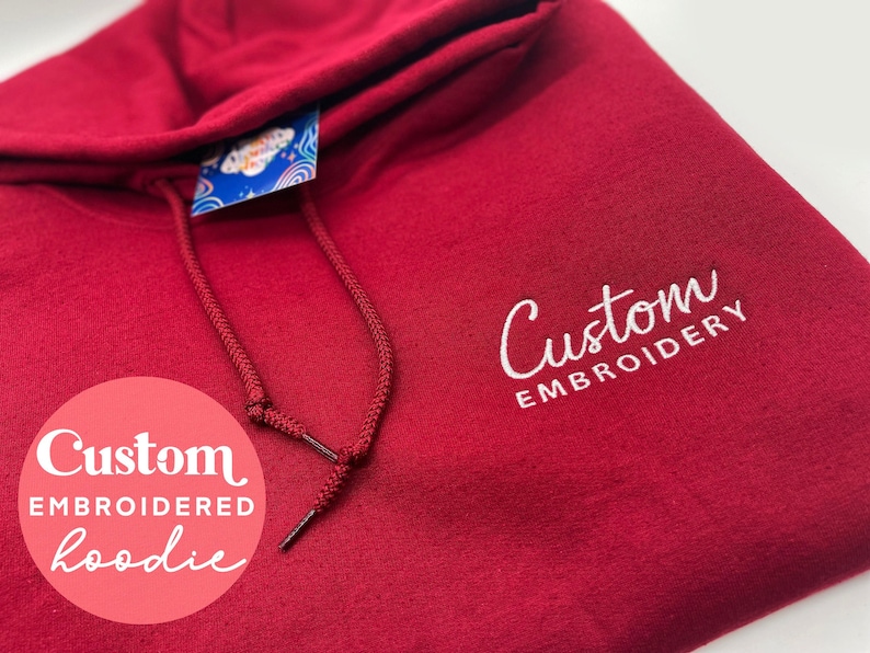 May include: A red hooded sweatshirt with white embroidery that says "Custom Embroidery".