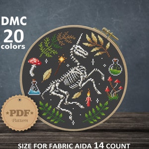 May include: A cross-stitch pattern featuring a skeleton unicorn with a black background. The pattern includes mushrooms, leaves, and other magical elements. The pattern is 106 x 106 stitches and measures 7.57 x 7.57 inches.