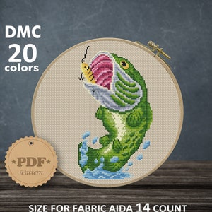 May include: Cross stitch pattern of a green fish jumping out of the water with a lure in its mouth. The pattern is for Aida 14 count fabric and measures 10.89 x 19.96 cm or 4.29 x 7.86 inches. The pattern requires 20 DMC colors.