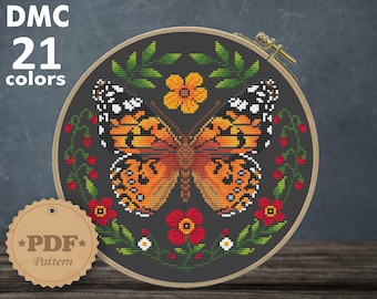 May include: A cross-stitch pattern featuring a butterfly with orange, black, and white wings surrounded by red, white, and yellow flowers on a dark grey background. The pattern is 112 x 110 stitches and measures 8.00 x 7.86 inches.