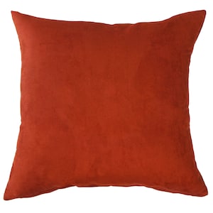 May include: A solid rust-colored throw pillow with a soft, suede-like texture.