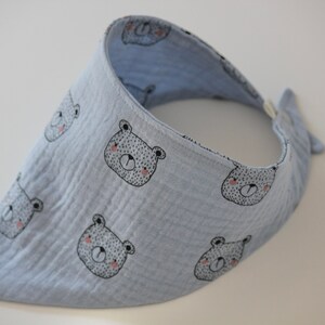 May include: A light blue bandana with a white bear print. The bandana is made of soft, absorbent fabric and is perfect for keeping baby's clothes clean.