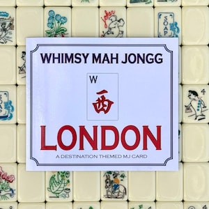 May include: A white card with the text "WHIMSY MAH JONGG" and "LONDON" in red, with a Chinese symbol and the letter "W". The card is surrounded by Mah Jongg tiles with various illustrations.