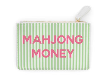 May include: A white and green striped zippered pouch with the words "MAHJONG MONEY" in pink. The pouch has a white zipper pull and a gold-colored zipper.