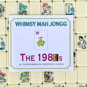May include: A card from the "Whimsy Mah Jongg" series, titled "The 1980s." The card features a green and white design with the letter "W" and a Chinese character. The card is set against a backdrop of ivory-colored Mah Jongg tiles.