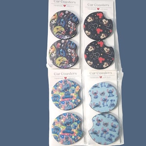 May include: Eight circular car coasters packaged in pairs on four white cards labeled Car Coasters. The coasters feature various character prints including Jack Skellington, Mickey Mouse, and Stitch in blue, black, and multi-colored patterns.